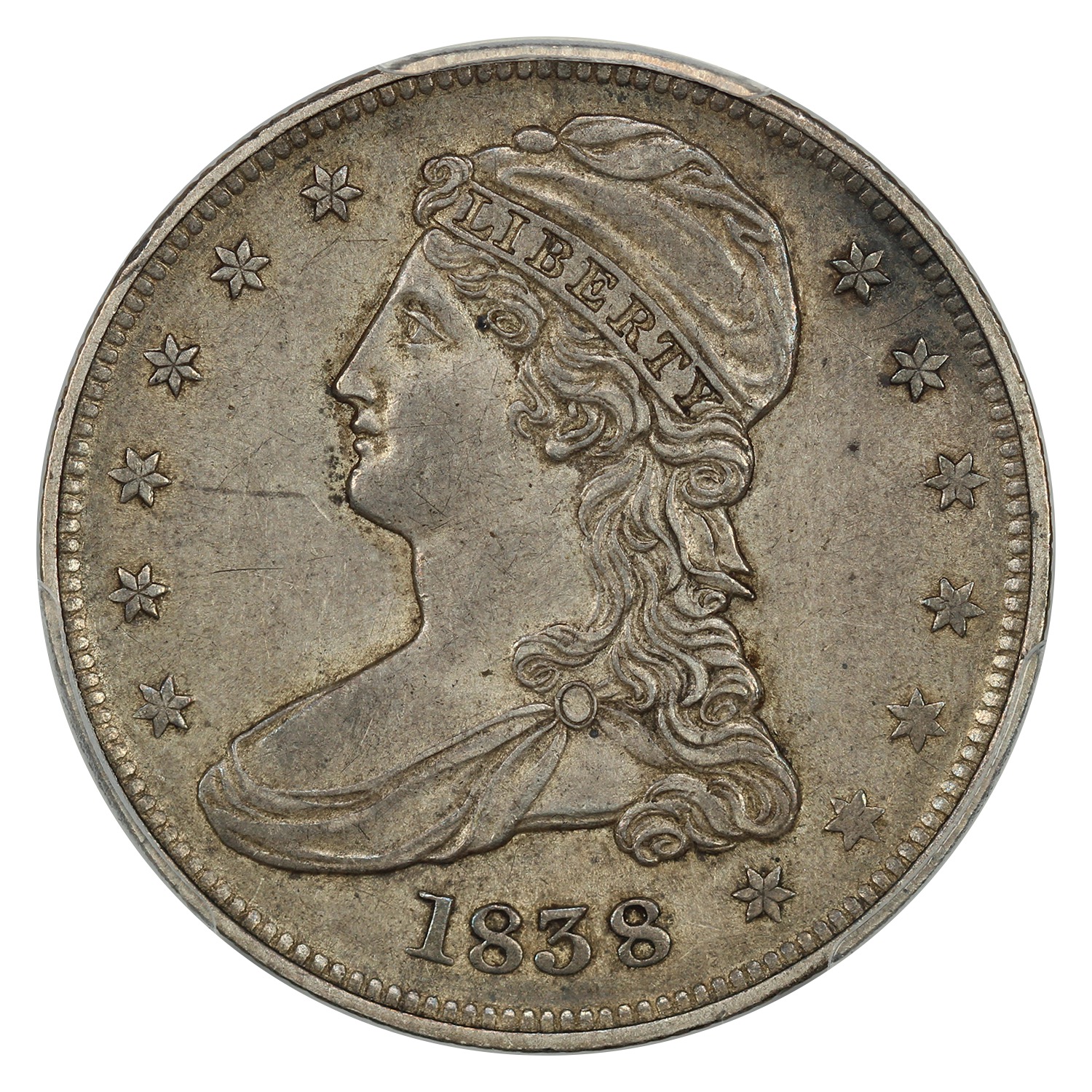 The obverse of a raw 1838 Reeded Edge half dollar.