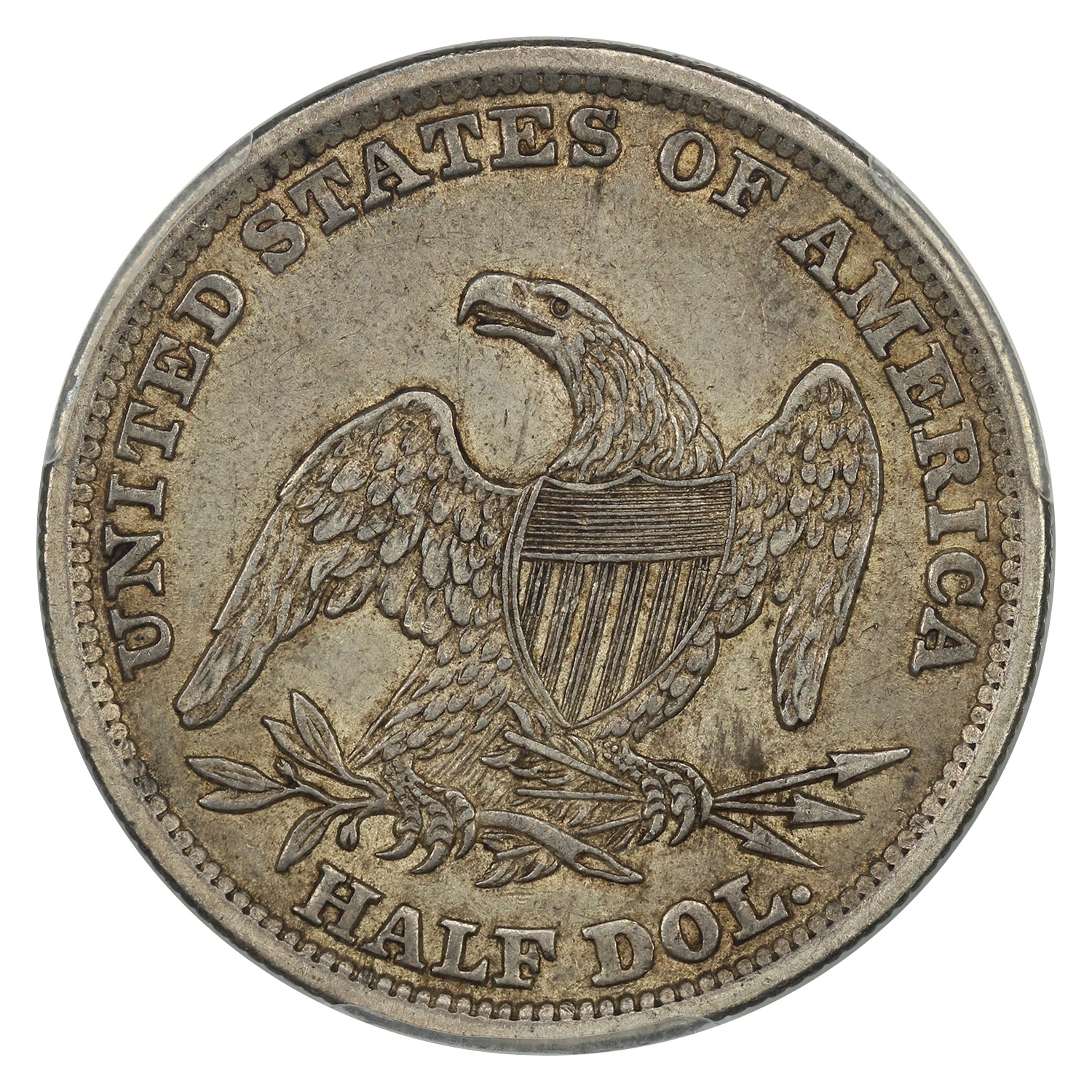 The reverse of a raw 1838 Reeded Edge half dollar.