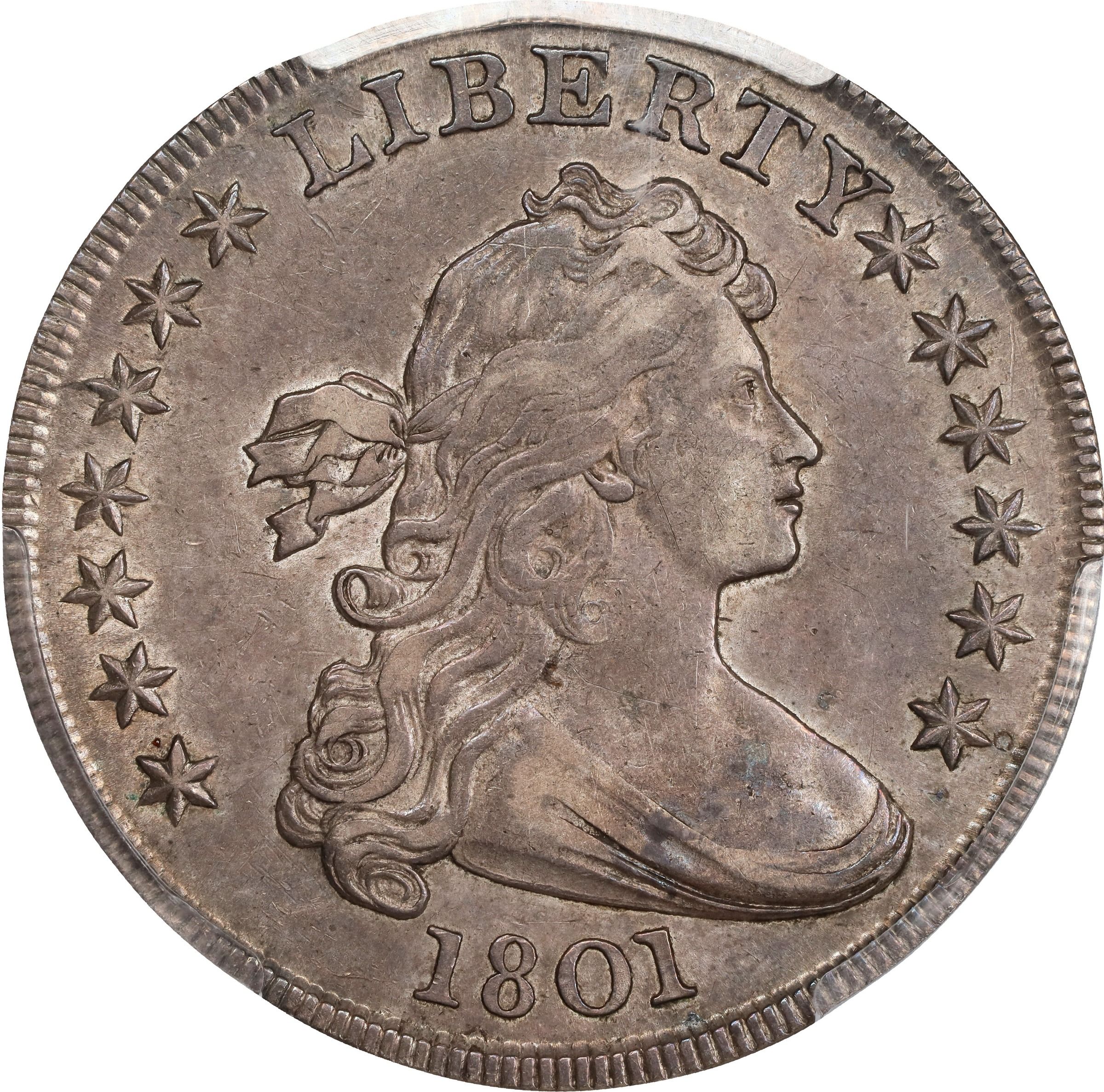 The obverse of a raw 1801 draped bust dollar.